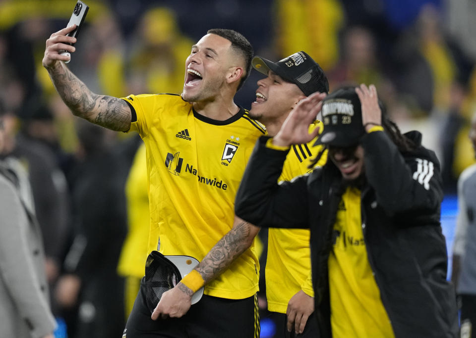 Columbus Crew forward Christian Ramirez, left, forward Cucho Hernández, center, and defender Mohamed Farsi (23) celebrate after an MLS Eastern Conference Final soccer match against FC Cincinnati, Saturday, Dec. 2, 2023, in Cincinnati. Columbus won 3-2 in overtime. (AP Photo/Carolyn Kaster)