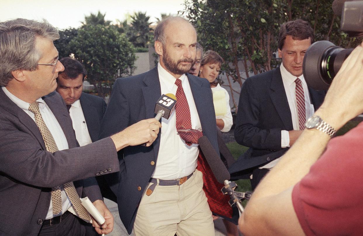 FILE - Former Exxon Valdez Capt. Joseph Hazelwood is surrounded by reporters as he leaves his re-licensing hearing in Long Beach, Calif., on July 25, 1990. 