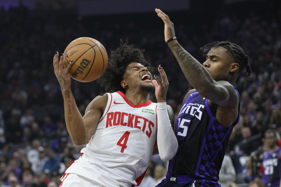 Houston Rockets guard Jalen Green (4) is fouled by Sacramento Kings guard Davion Mitchell during the first half of an NBA basketball game in Sacramento, Calif., Sunday, March 10, 2024. (AP Photo/Randall Benton)