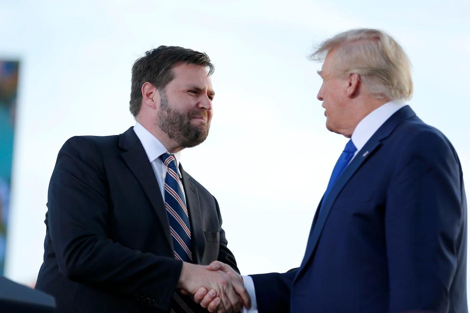 Senate candidate JD Vance greets former President Donald Trump at a rally on April 23, 2022, in Delaware, Ohio.