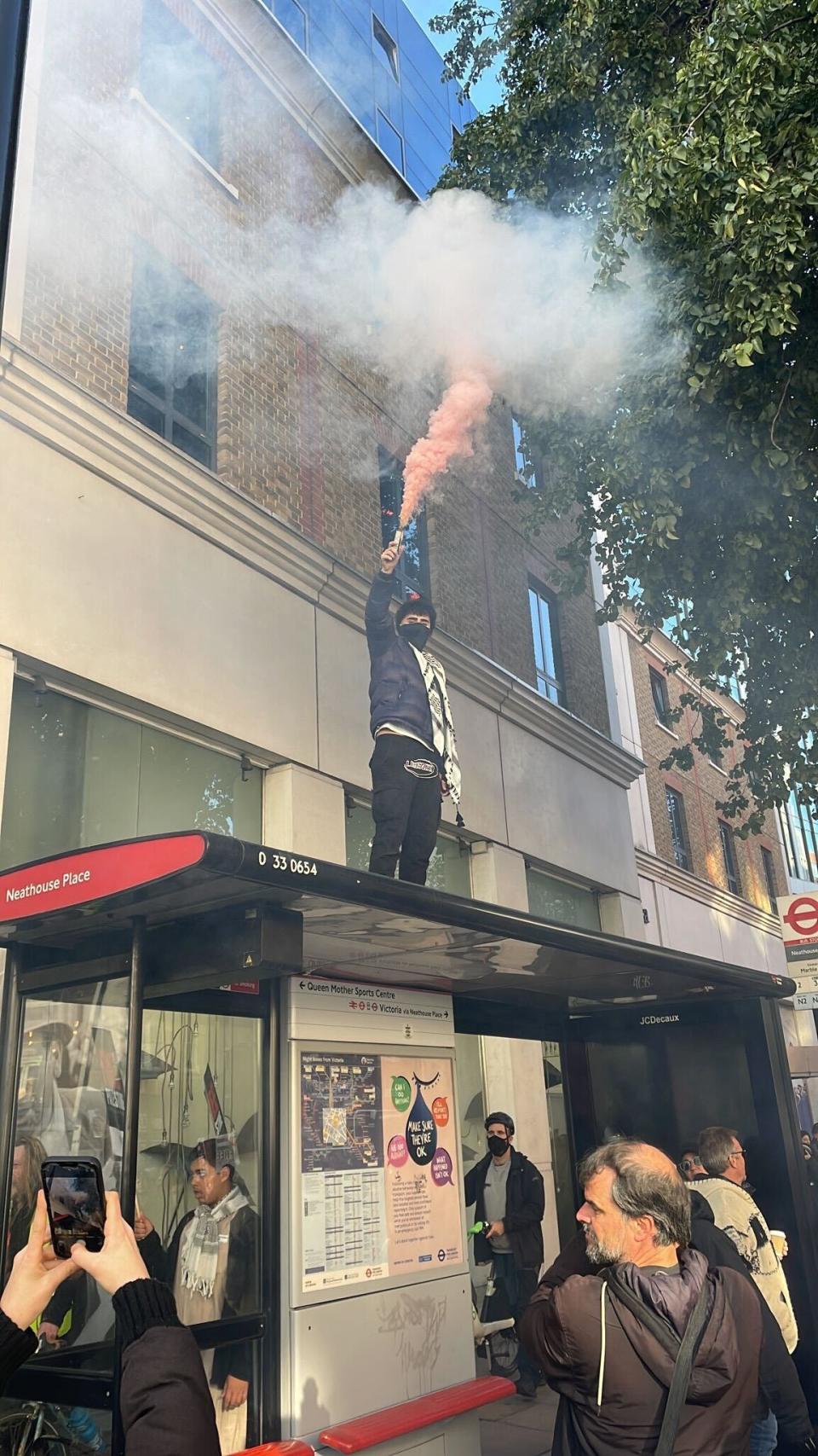 The protestor stood on the Neathouse Place bus stop in Victoria (Provided)