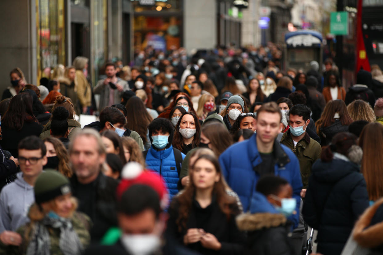 Shoppers, some wearing face masks, walk along a busy Oxford Street in London, England, on December 5, 2020. London has returned to so-called Tier 2 or 'high alert' coronavirus restrictions since the end of the four-week, England-wide lockdown last Wednesday, meaning a reopening of non-essential shops and hospitality businesses as the festive season gets underway. Rules under all three of England's tiers have been strengthened from before the November lockdown, however, with pubs and restaurants most severely impacted. In London's West End, meanwhile, Oxford Street and Regent Street were both packed with Christmas shoppers this afternoon, with the retail sector hoping for a strong end to one of its most difficult years. (Photo by David Cliff/NurPhoto via Getty Images)