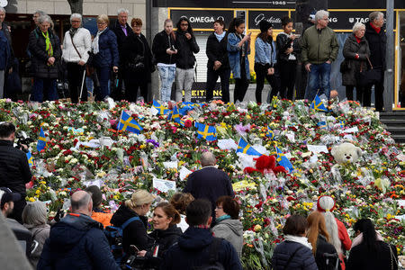 People leaving flowers on the steps in Sergels Torg following Friday's terror attack in central Stockholm, Sweden, Sunday, April 9, 2017. Noella Johansson/TT News Agency via REUTERS