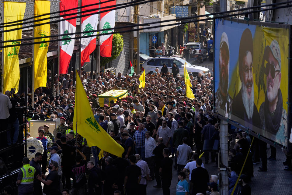 People carry the coffin of Hezbollah fighter, Ali Ibrahim Rmeiti, who was killed by Israeli shelling, during his funeral procession in the southern Beirut suburb of Dahiyeh, Lebanon, Saturday, Nov. 4, 2023. (AP Photo/Bilal Hussein)