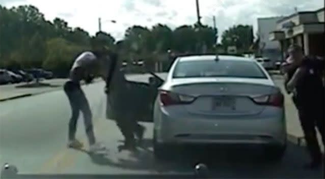 They then struggled near the car. Photo: AP