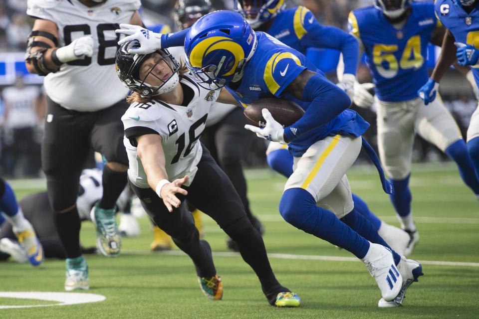 Los Angeles Rams cornerback Jalen Ramsey (5) stiff arms Jacksonville Jaguars quarterback Trevor Lawrence (16) on Sunday, Dec. 5, 2021, in Inglewood, Calif.