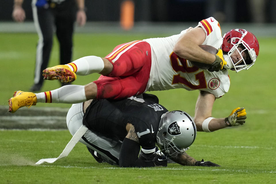 Kansas City Chiefs tight end Travis Kelce, top, is tackled by Las Vegas Raiders safety Marcus Epps during the second half of an NFL football game, Sunday, Nov. 26, 2023, in Las Vegas. (AP Photo/John Locher)