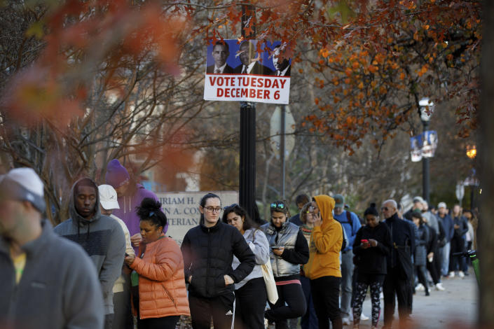رای دهندگان جورجیا در روز جمعه، 2 دسامبر 2022 در خارج از محل رای گیری در کتابخانه پونس دی لئون در آتلانتا منتظر هستند تا رای خود را به صندوق بیندازند. (داستین چمبرز/نیویورک تایمز)