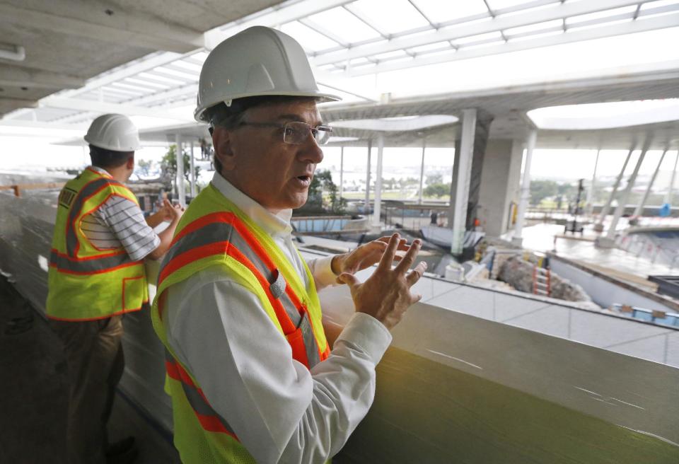 In this Thursday, Dec. 8, 2016 photo, Frank Steslow, president of the Patricia and Phillip Frost Museum of Science, points out the progress in construction during a tour of the museum in Miami. Rising next to Miami's spiffy new bayside art museum is a $305 million science museum that, like South Florida, is focused in large part on water: its centerpiece is a 500,000-gallon aquarium that will feature sharks, tuna, mahi-mahi and even sea turtles, with other smaller tanks for corals and other sea life. The Frost Science Museum, scheduled to open this spring. (AP Photo/Wilfredo Lee)