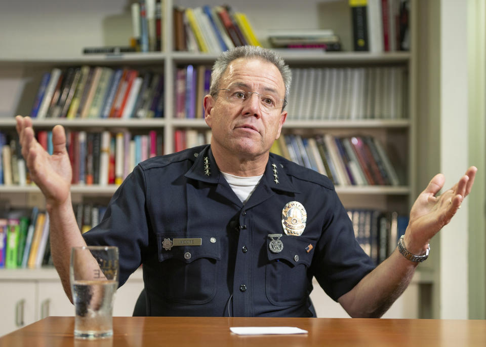 In this Wednesday, July 10, 2019, photo Los Angeles Police Department Chief Michel Moore talks during an interview with The Associated Press in Los Angeles. Moore said he doesn't see homelessness as a law enforcement issue, but rather a public health and safety concern that requires mental health, sanitation, hygiene and housing resources. He said the homeless population sees police officers and firefighters on the streets at 3 a.m., but not anyone uniformed who can provide other services. (AP Photo/Damian Dovarganes)