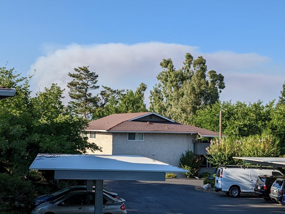 The Wonder Fire sends up a thick smoke plume north of Redding on Monday, July 25, 2023.