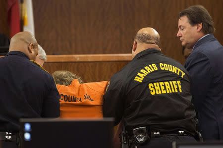 Accused mass shooter Ronald Lee Haskell collapses as he appears in court on in Houston, Texas July 11, 2014. REUTERS/Brett Coomer/Pool