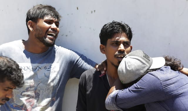 Relatives mourn outside a hospital in Colombo 