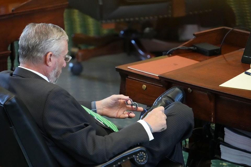 Sen. Drew Springer, R-Muenster, plays with a fidget toy during Attorney General Ken Paxton's impeachment trial in the Texas Senate at the Capitol in Austin on Friday, Sept. 8, 2023.
