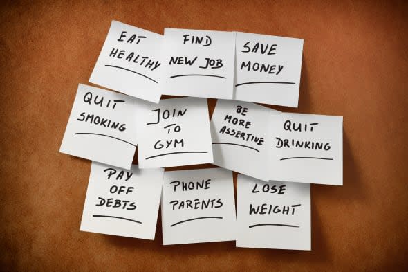 New Year's resolutions written on pieces of paper and stuck to the table