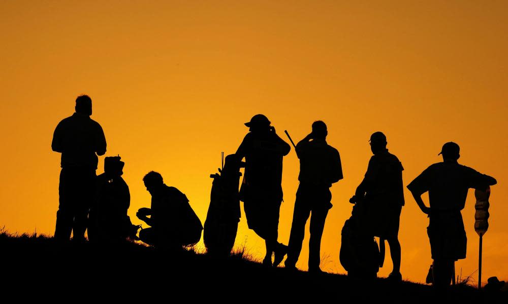 Golfers wait at a hole
