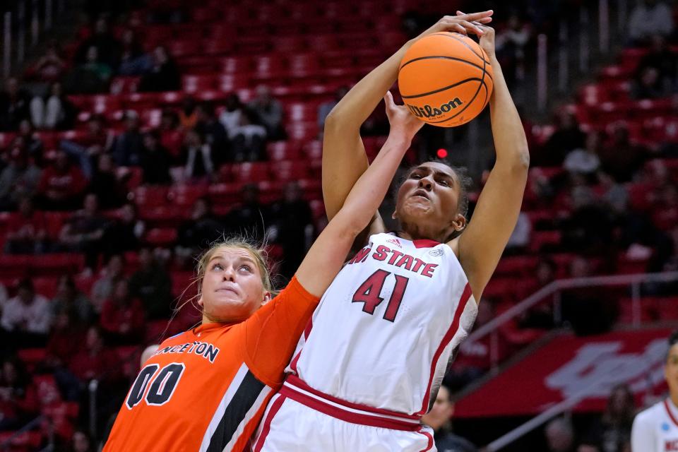 N.C. State center Camille Hobby (41) reaches for a rebound along with Princeton's Ellie Mitchell (00) during the NCAA Tournament.