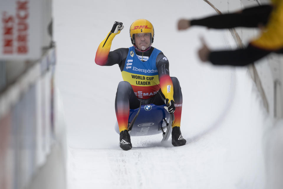 Felix Loch of Germany celebrates after his 2nd run during the Luge World Cup event in Innsbruck, Austria, Saturday, Jan. 23, 2021. (AP Photo/Andreas Schaad)