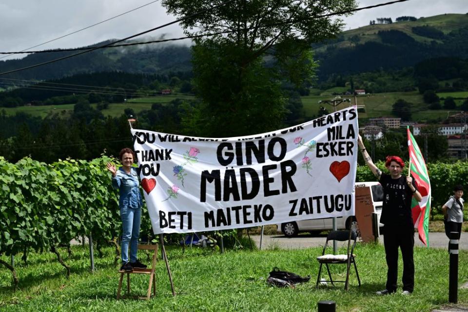 Spectators deploy a banner paying tribute to the late Swiss Cyclist Gino Mader who died in the June 2023 Tour of Switzerland after plunging into a ravine during the 2nd stage of the 110th edition of the Tour de France cycling race 2089 km between VitoriaGasteiz and San Sebastian in northern Spain on July 2 2023 Photo by Marco BERTORELLO  AFP Photo by MARCO BERTORELLOAFP via Getty Images