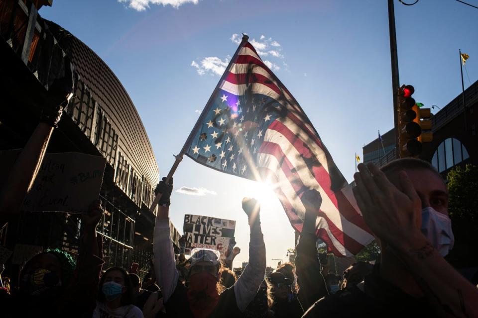 Maga supporters parade the upside-down flag (Copyright 2020 The Associated Press. All rights reserved.)