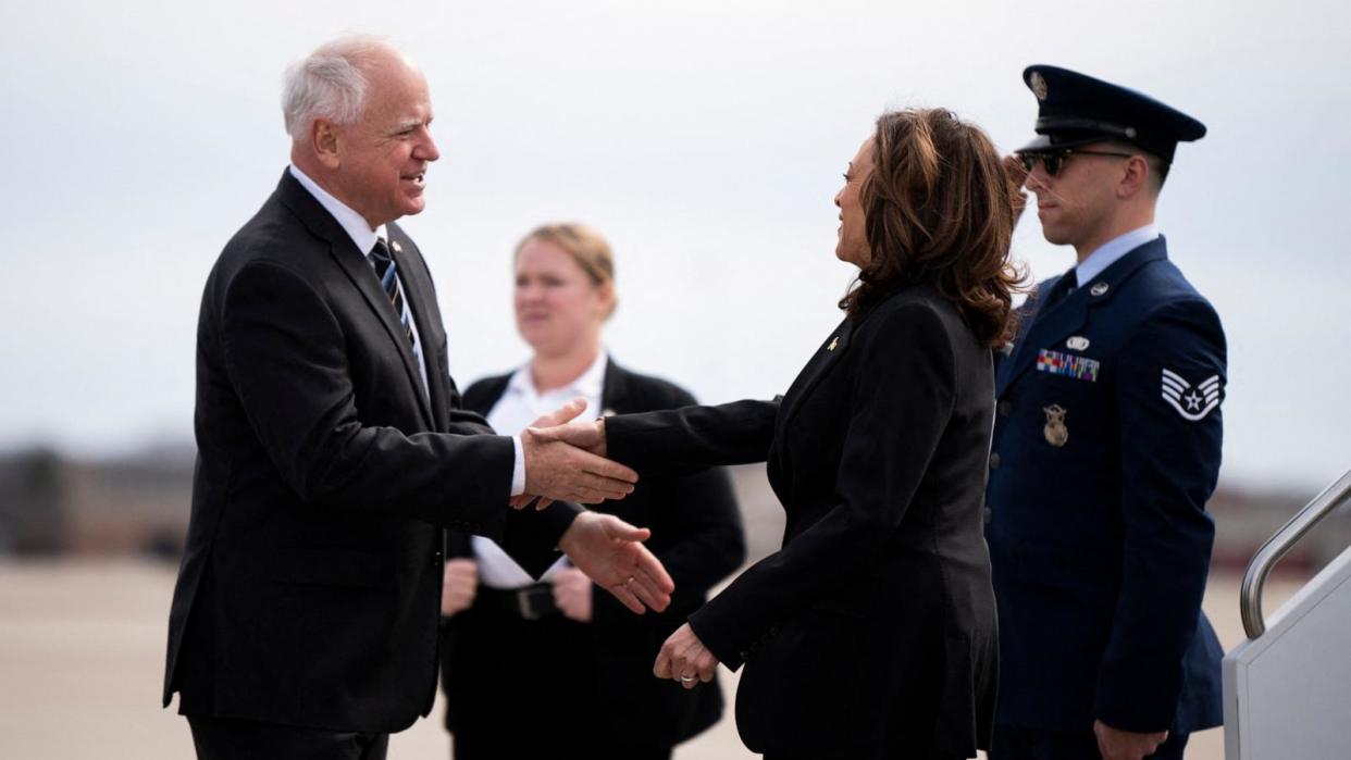 PHOTO: Minnesota Governor Tim Walz greets US Vice President Kamala Harris as she arrives at the Minneapolis-St. Paul International Airport in Saint Paul, Minn., on March 14, 2024.  (Stephen Maturen/AFP via Getty Images, FILE)