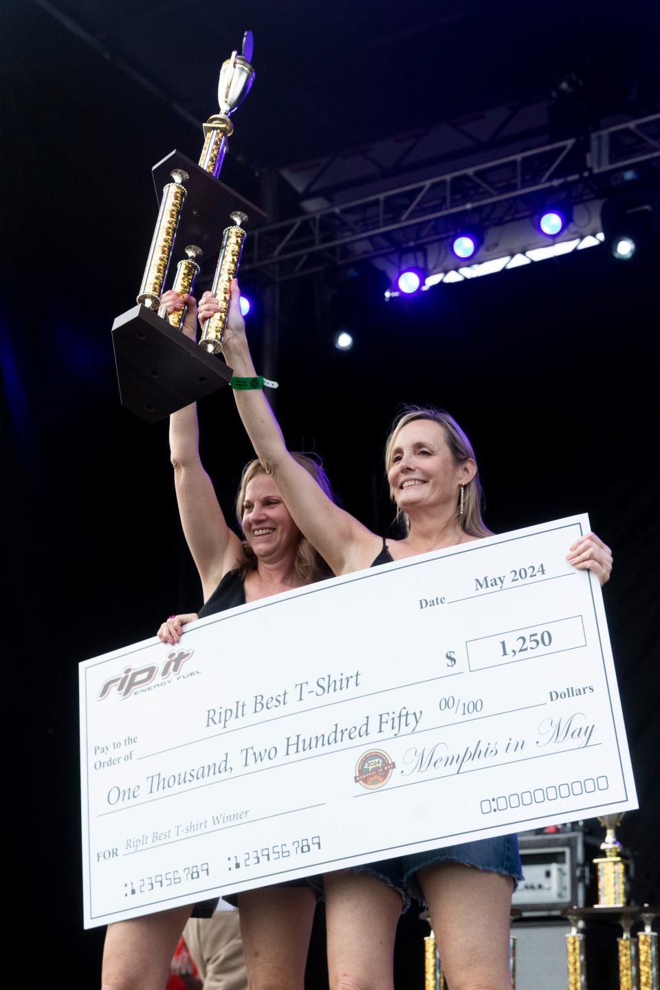 Team members from Porkcrastinators celebrate receiving first place in the “Best T-Shirt” contest during the World Championship Barbecue Cooking Contest as part of the Memphis in May International Festival in Memphis, Tenn., on Thursday, May 16, 2024.