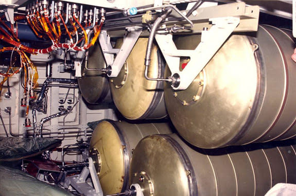 Photo showing the potable and waste water storage tanks on the lower deck of the space shuttle. The California Science Center is letting NASA remove the tanks from inside the shuttle Endeavour for use aboard the International Space Station.