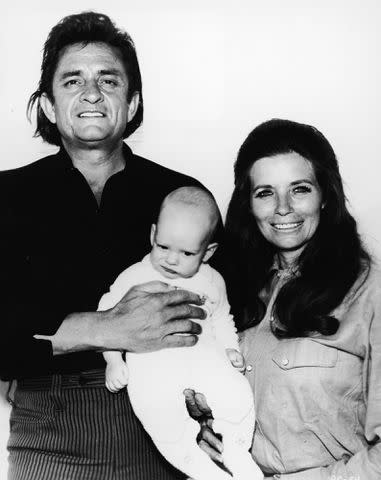 <p>Paramount Pictures/Courtesy of Getty</p> Johnny Cash and his wife June Carter Cash with their infant son John Carter Cash in a promotional portrait for the film 'A Gunfight' in 1970.