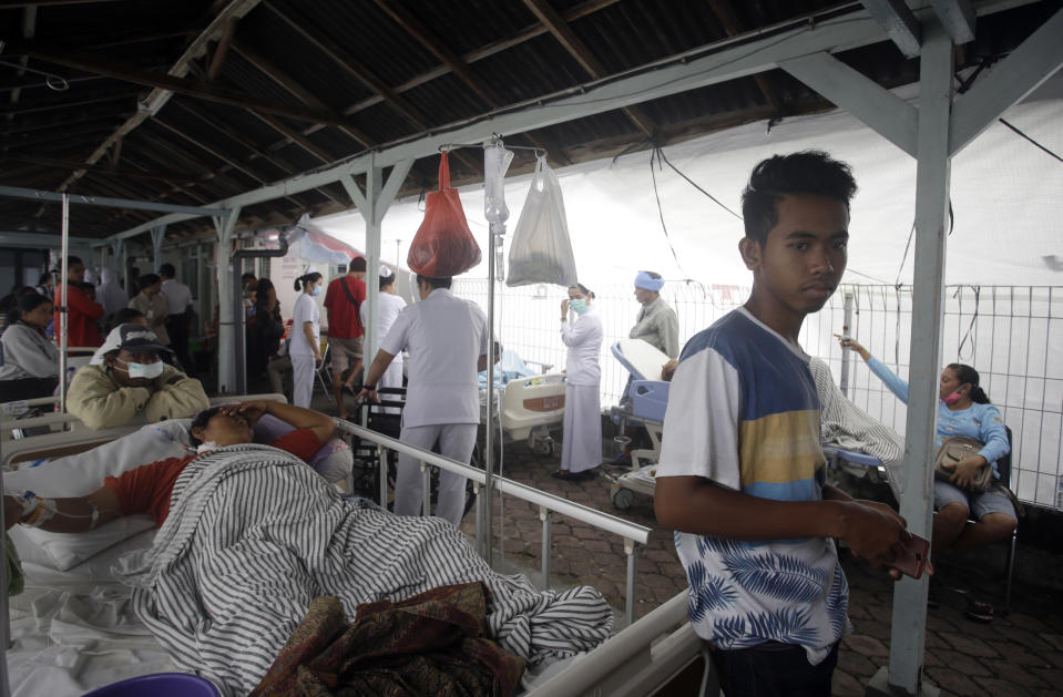 Patients are evacuated outside a hospital following an earthquake in Bali, Indonesia, Monday, Aug. 6, 2018. A powerful earthquake struck the Indonesian tourist island of Lombok on Sunday, shaking neighboring Bali, one week after another quake on Lombok killed more than a dozen. (AP Photo/Firdia Lisnawati)