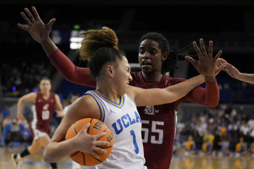 Washington State center Bella Murekatete, right, defends against UCLA guard Kiki Rice during the second half of an NCAA college basketball game, Sunday, Jan. 28, 2024, in Los Angeles. (AP Photo/Ryan Sun)