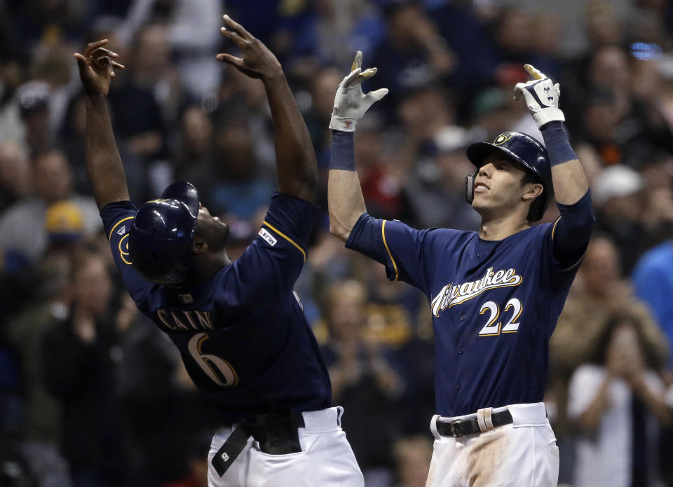 Milwaukee Brewers' Christian Yelich (22) celebrates with Lorenzo Cain (6) after hitting a three-run home run during the fifth inning of the team's baseball game against the St. Louis Cardinals on Tuesday, April 16, 2019, in Milwaukee. (AP Photo/Aaron Gash)