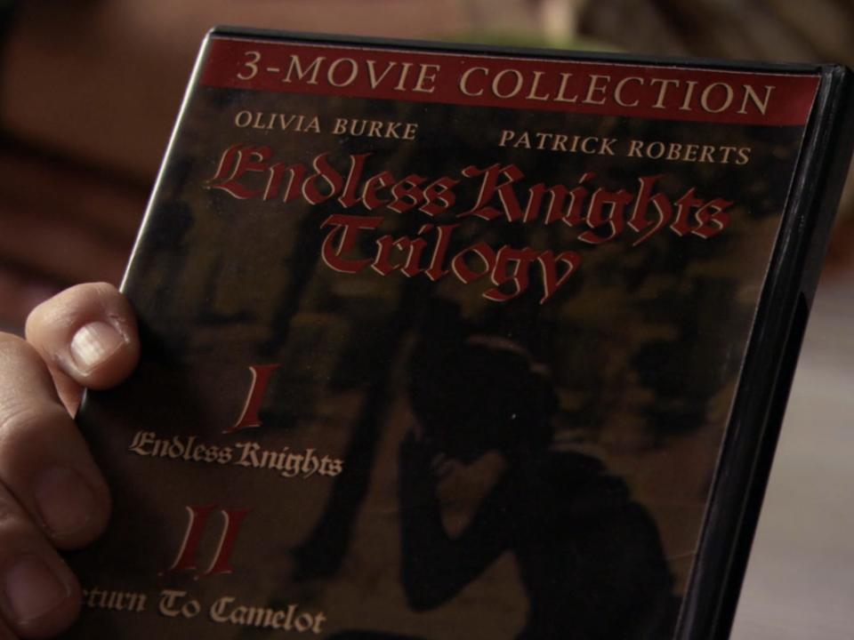 hand holding endless knights trilogy dvd on an episode of gossip girl