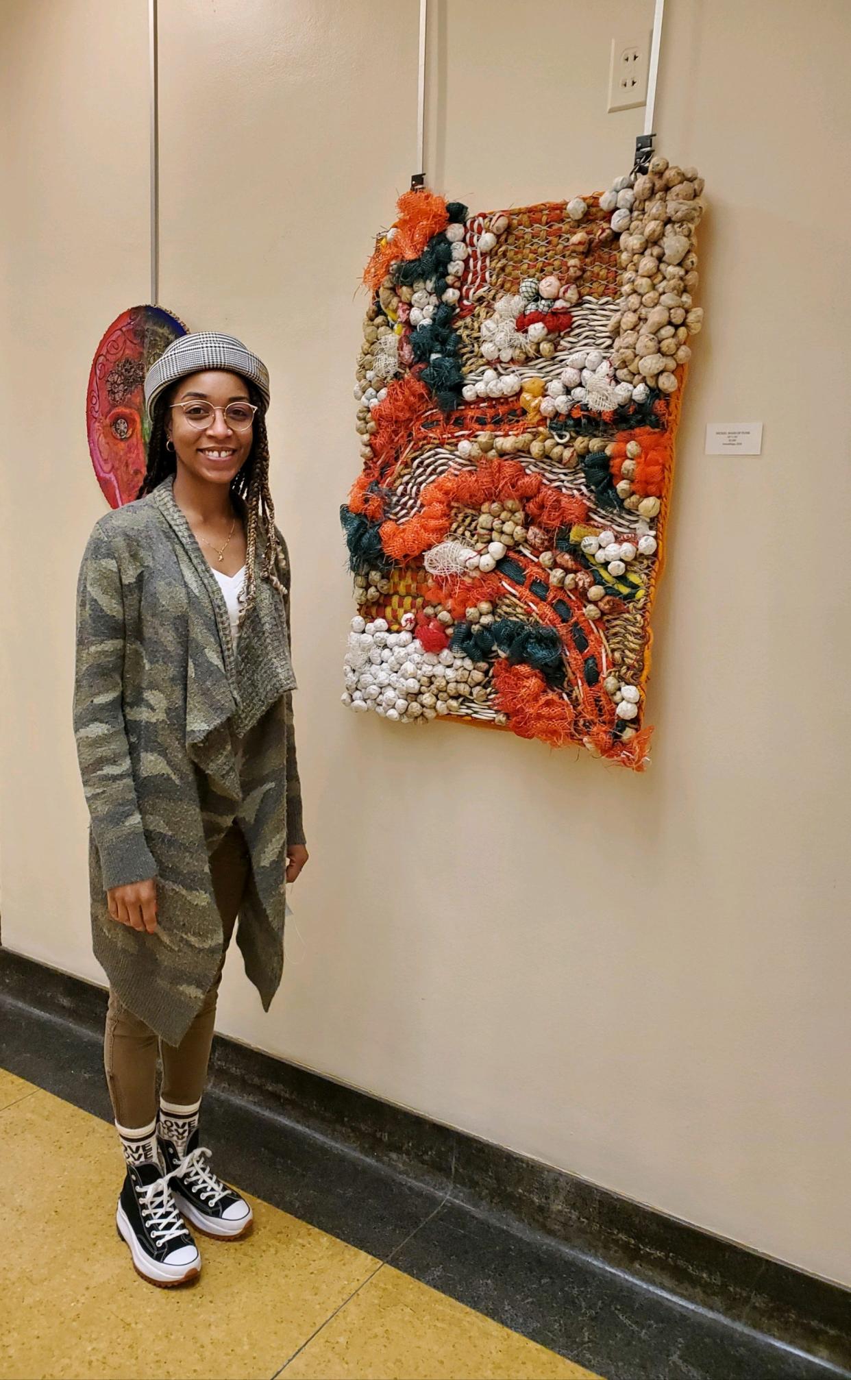 Artist Tiffany Lawson shows a piece of her collection titled “Nickel Bags of Funk.”