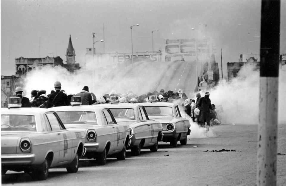 FILE - Tear gas fills the air as state troopers, ordered by Alabama Gov. George Wallace, break up a march at the Edmund Pettus Bridge in Selma, Ala., March 7, 1965, on what became known as Bloody Sunday. On Sunday, March 5, 2023, President Joe Biden is set to pay tribute to the heroes of “Bloody Sunday," joining thousands for the annual commemoration of the seminal moment in the civil rights movement that led to passage of landmark voting rights legislation nearly 60 years ago. (AP Photo, File)