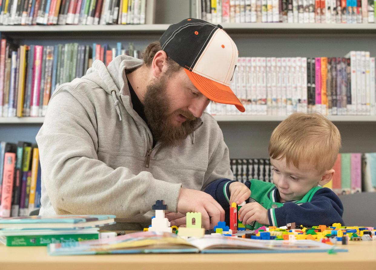 Father and son James McKelvey and Abraham, 3, of Louisville work on a project during the Lego/Duplo Club at the Stark Library East Canton Branch.