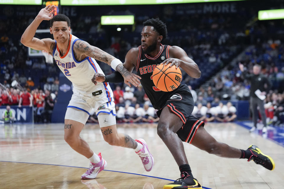 Georgia guard Noah Thomasson (3) drives against Florida guard Riley Kugel (2) during the first half of an NCAA college basketball game at the Southeastern Conference tournament Thursday, March 14, 2024, in Nashville, Tenn. (AP Photo/John Bazemore)