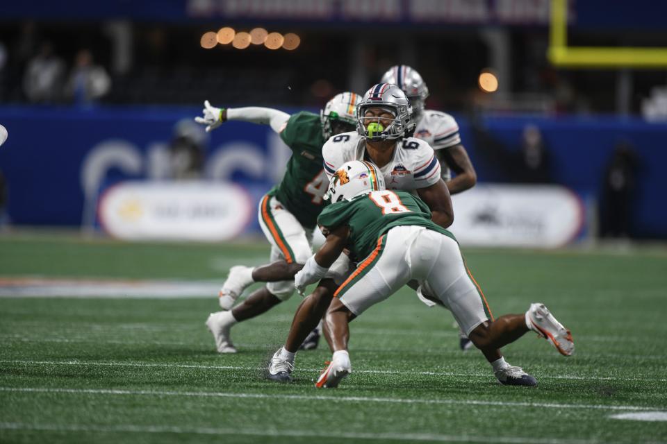 Florida A&M defensive back Eric Smith tackles Howard wide receiver Breylin Smith during the Celebration Bowl, Dec. 16, 2023.