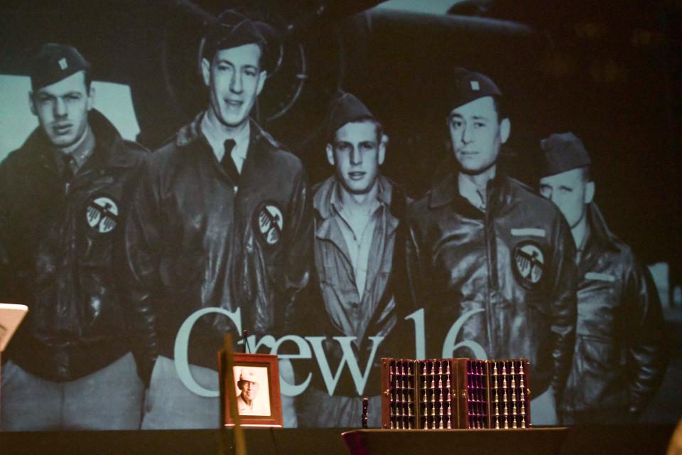 The 80 Doolittle Raider goblets sit before a photo of Air Crew 16 during a ceremony Monday at Northwest Florida State College's Mattie Kelly Arts Center. At left is Lt. Col. Richard "Dick" Cole, who passed away in April 2019. Cole and his fellow Raiders were toasted one last time during the ceremony.