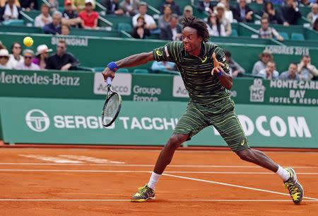 Gael Monfils of France returns the ball to Roger Federer of Switzerland during their match at the Monte Carlo Masters in Monaco April 16, 2015. REUTERS/Eric Gaillard