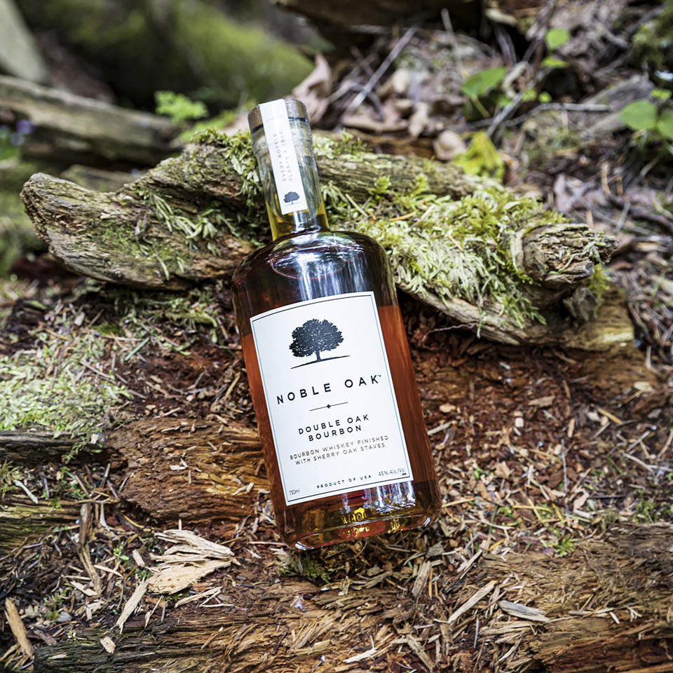 This image provided by Noble Oak shows a 750ml bottle of Noble Oak bourbon. For every bottle sold, the company plants a tree in partnership with One Tree Planted, a Vermont-based reforestation nonprofit. (Noble Oak via AP)