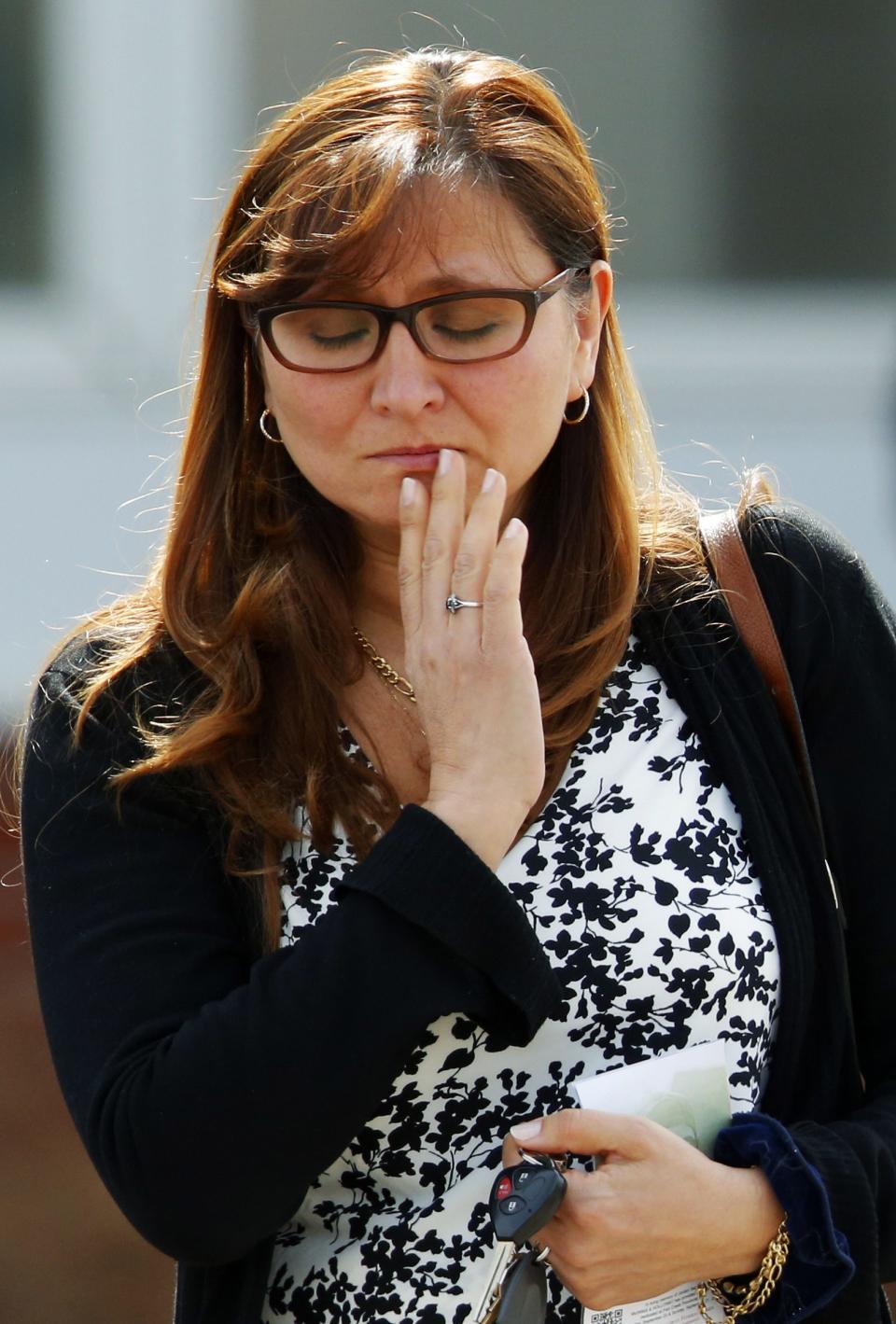 A woman pauses after the funeral of Jordan Segura in Calgary