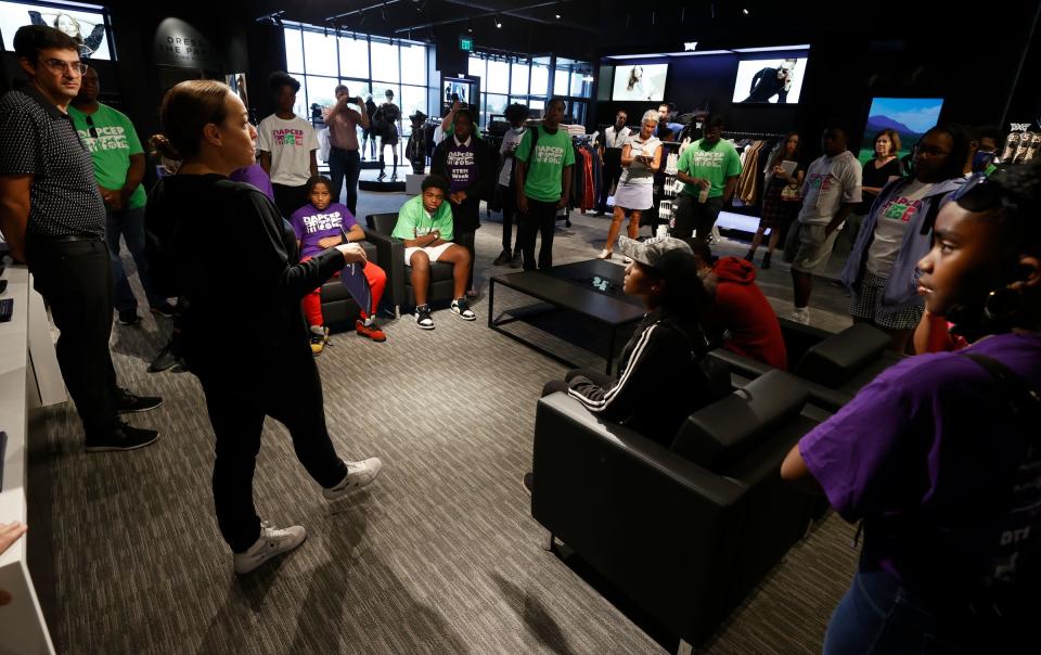 Leela Brennan, vice president of brand communications for PXG (Parsons Extreme Golf), far left, talks to students before they went off to four different stations in the golf store during the one-day DAPCEP camp at PXG Golf in Troy on July 27, 2022. Nineteen students from the metro Detroit school learned the science and engineering of golf from the clubs to ball striking.