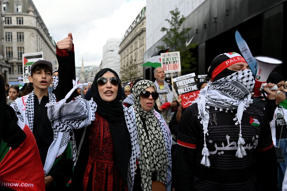 LONDON, UNITED KINGDOM - OCTOBER 14: People waving Palestinian flags, gather to stage a demonstration to support Palestinians and condemn the Israel's attack, in London, United Kingdom on October 14, 2023. Groups supporting Palestine protest at Israel's retaliation to Hamas attacks across the UK this weekend despite the Home Secretary, Suella Braverman, suggesting that waving Palestinian flags and using popular pro-Palestine slogans could be illegal under the Public Order Act in a letter she sent to police chiefs in England and Wales on Tuesday. (Photo by Kate Green/Anadolu via Getty Images)