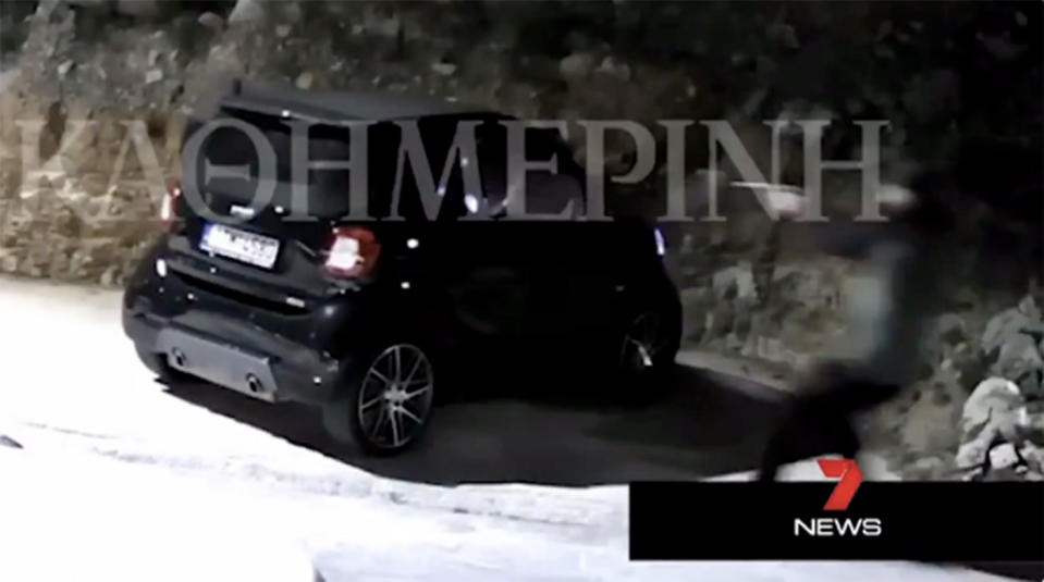 The footage shows a gunman firing at John Macris's vehicle outside his home in Voula, Greece.