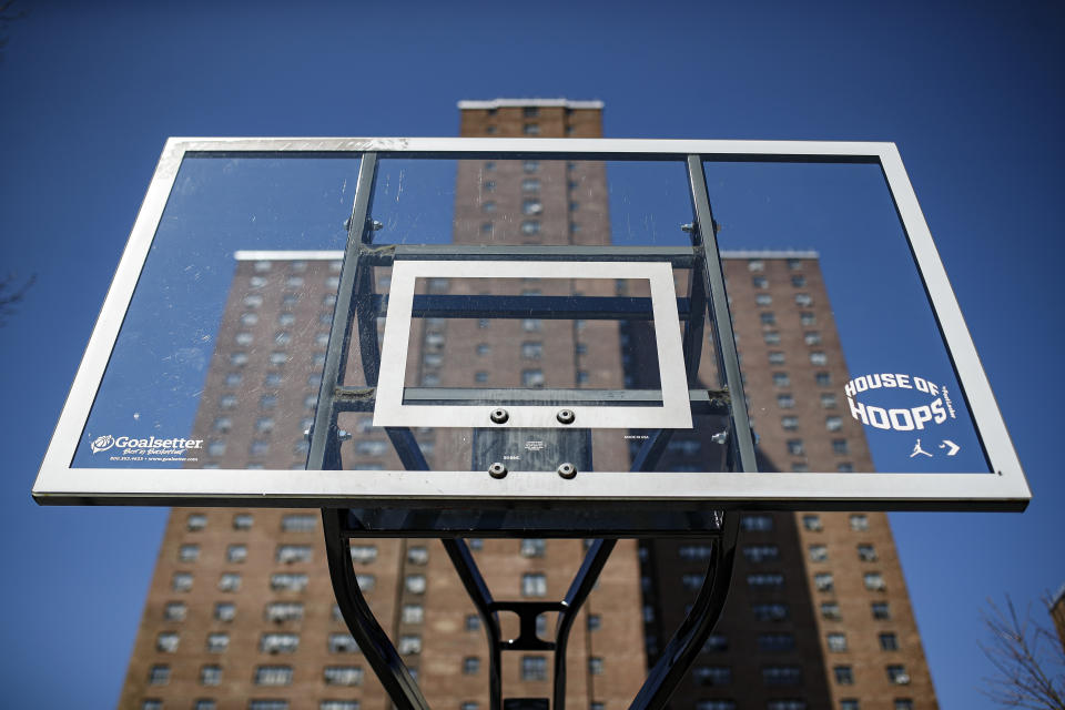 Basketball backboards stand without hoops after city officials had them removed to reduce gatherings at Holcombe Rucker Park, Thursday, March 26, 2020, in New York. Across the U.S., police departments are taking a lead role in enforcing social distancing rules that health officials say are critical to containing the coronavirus. In New York City, they've started dismantling basketball hoops to prevent people from gathering in parks and playing. (AP Photo/John Minchillo)