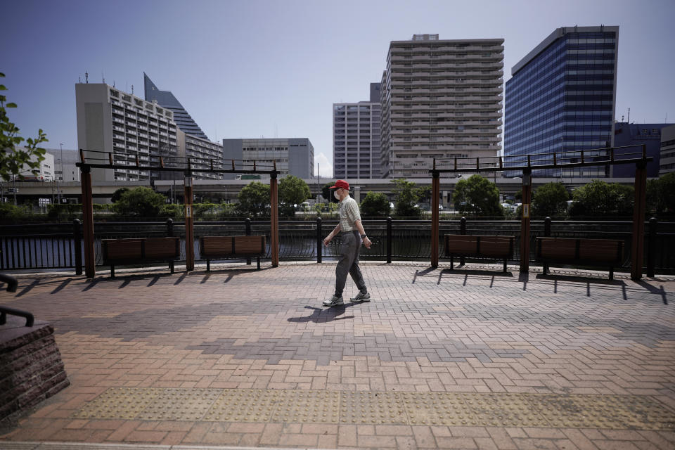 Hidekazu Tamura, 99, takes a walk as a daily routine in Tokyo Friday, Aug. 28, 2020. Amid commemorations for Wednesday's 75th anniversary of the formal Sept. 2 surrender ceremony that ended WWII, Tamura, a former Japanese American living in California, has vivid memories of his time locked up with thousands of other Japanese-Americans in U.S. intern camps. Torn between two warring nationalities, the experience led him to refuse a loyalty pledge to the United States, renounce his American citizenship and return to Japan. (AP Photo/Eugene Hoshiko)