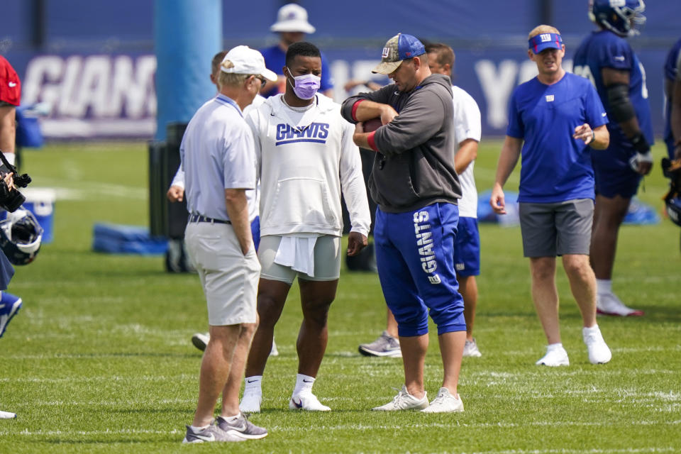 New York Giants president and CEO John Mara, left, running back Saquon Barkley center, and head coach Joe Judge gather at NFL football training camp, Wednesday, July 28, 2021, in East Rutherford, N.J. (AP Photo/Corey Sipkin)