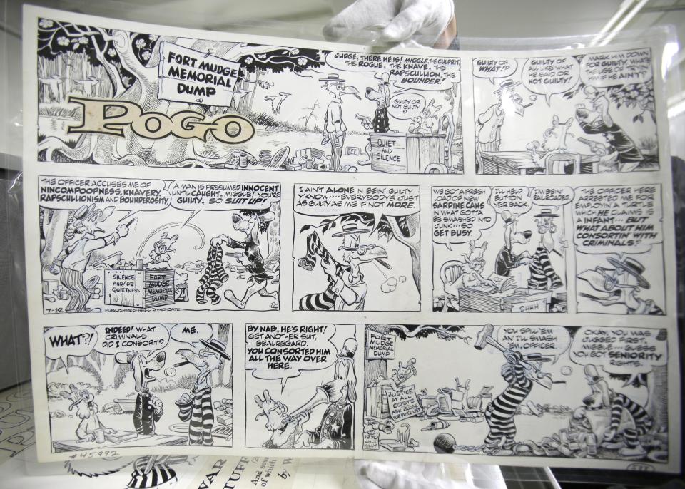 This Wednesday, Oct. 23, 2013 photo shows a comic titled "Pogo" by Walt Kelly at the Billy Ireland Cartoon Library & Museum in Columbus, Ohio. Today the museum collection includes more than 300,000 original strips from everybody who’s anybody in the newspaper comics world, plus 45,000 books, 29,000 comic books and 2,400 boxes of manuscript material, correspondence and other personal papers from artists. (AP Photo/Tony Dejak)