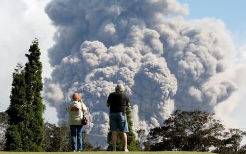 People watch ash erupt from the Halemaumau Crater on Saturday - Credit:  TERRAY SYLVESTER/Reuters