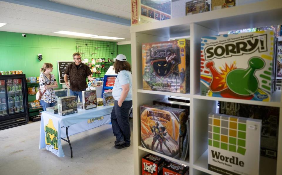 Rob Van Tuinen, right, talks with Scott Harness and his daughter Heather at Meeple Valley Board Game Cafe in Modesto, Calif., Thursday, March 21, 2024.